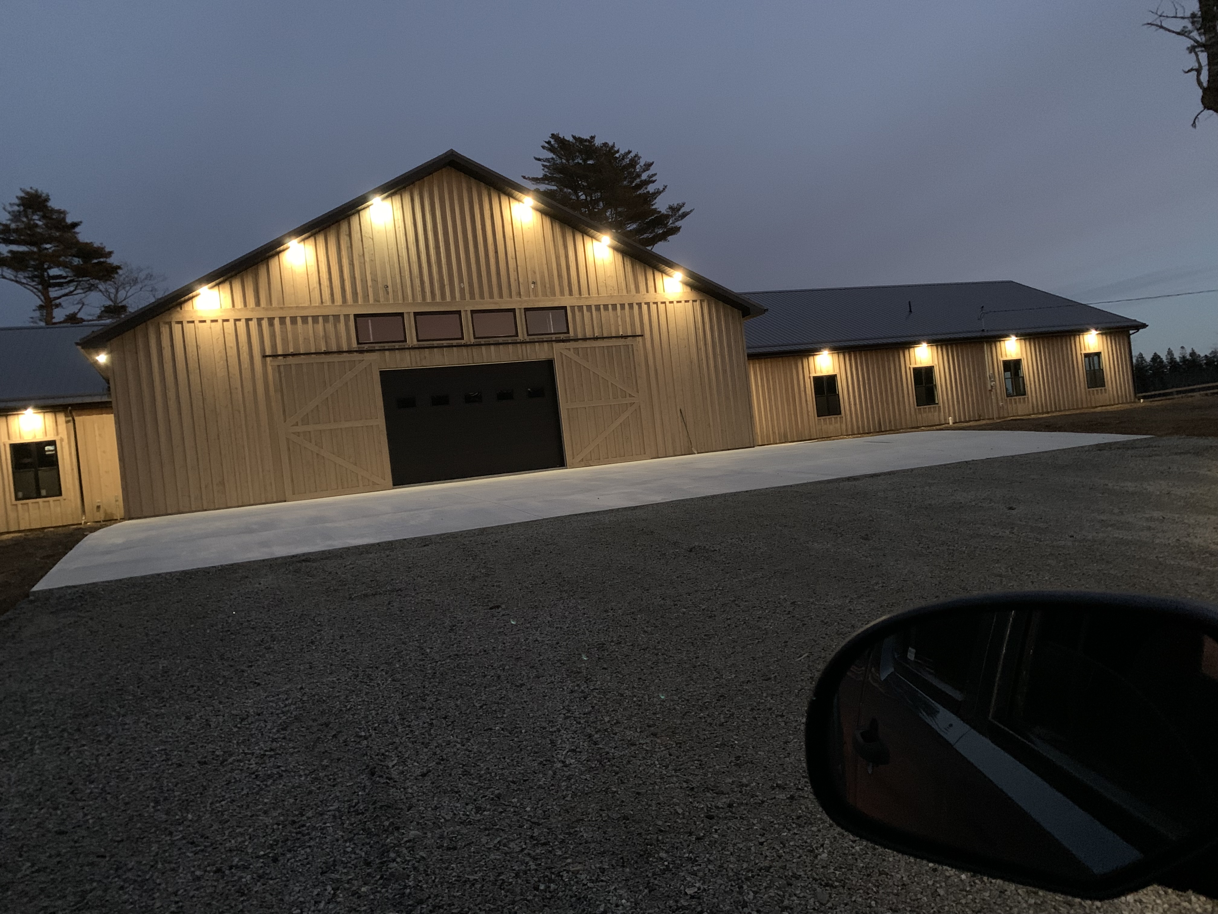 High-end residential barn exterior lighting at dusk