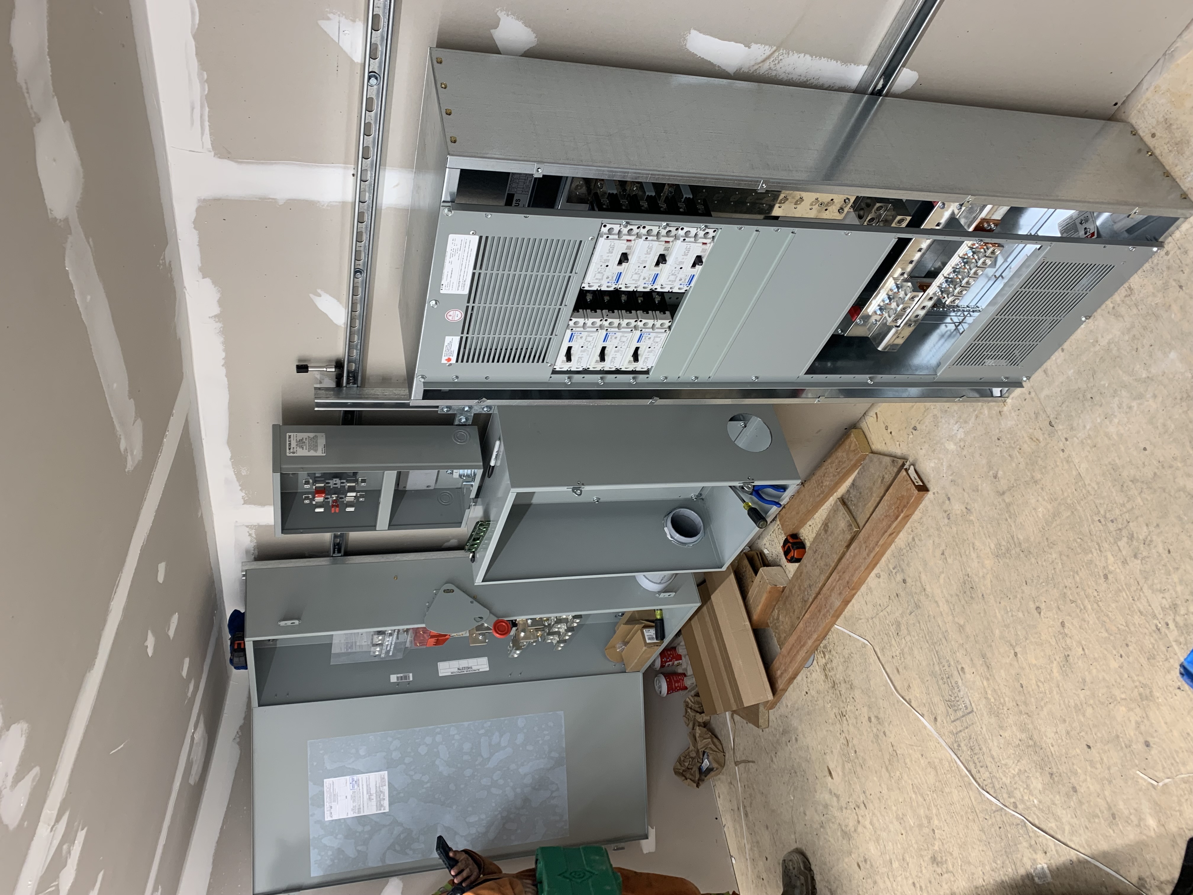 Electrical room showing large service distribution equipment during installation