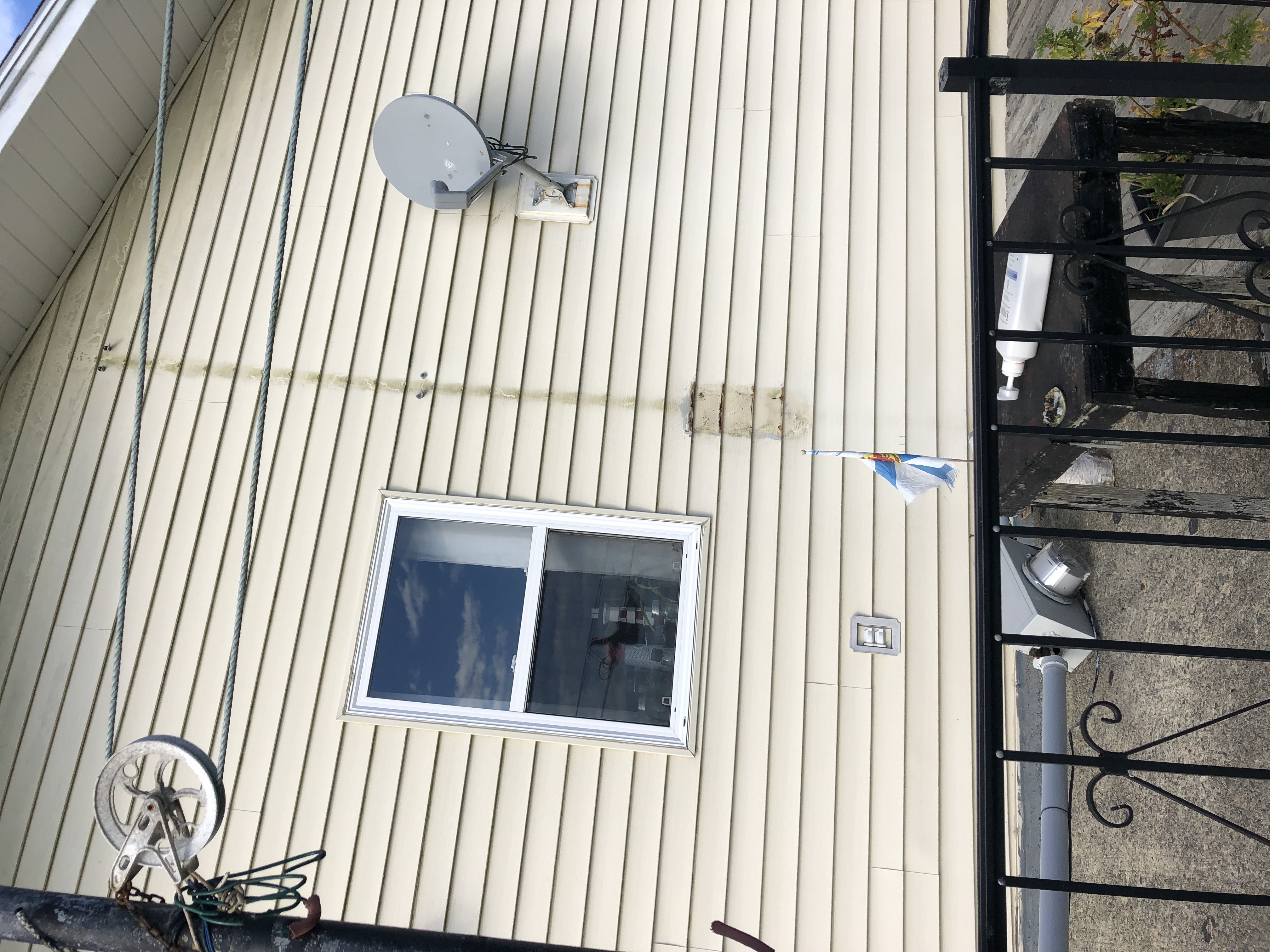 House exterior showing where the electrical service was ripped off after storm damage
