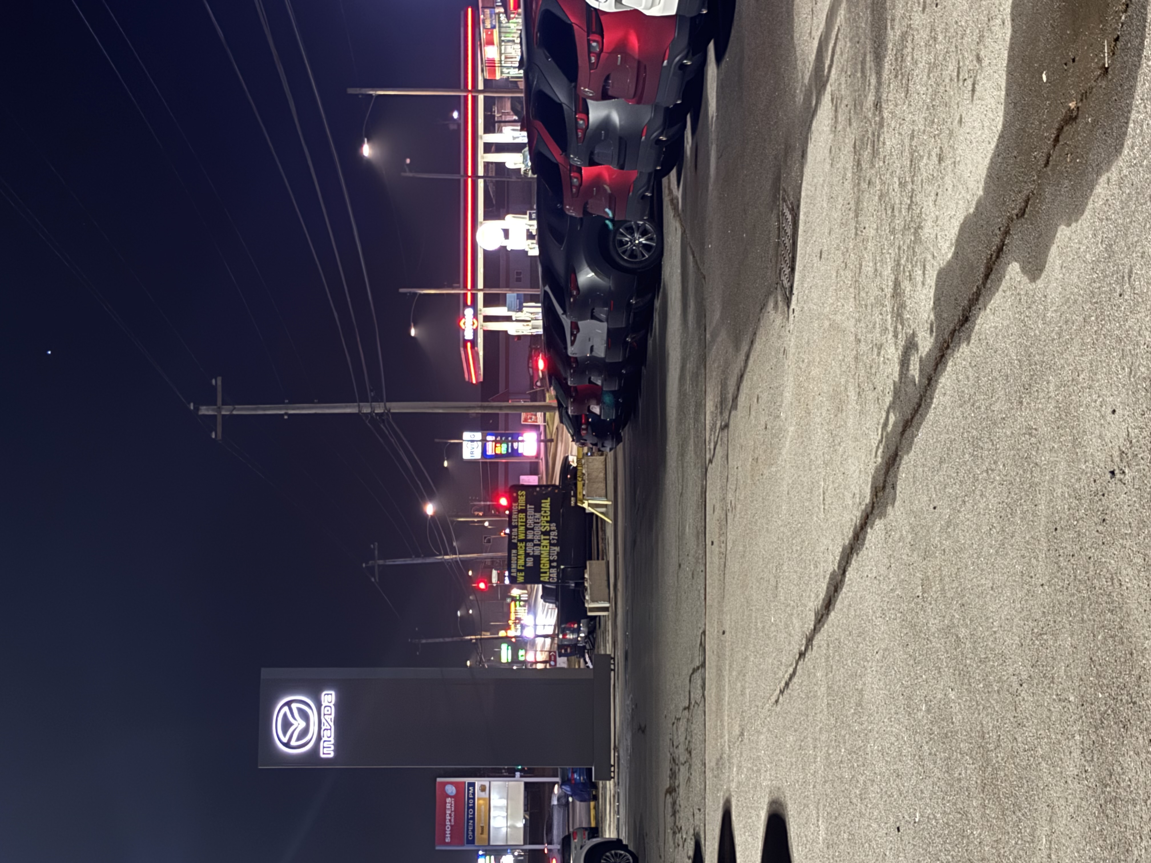 Finished Mazda pylon sign illuminated at night following installation