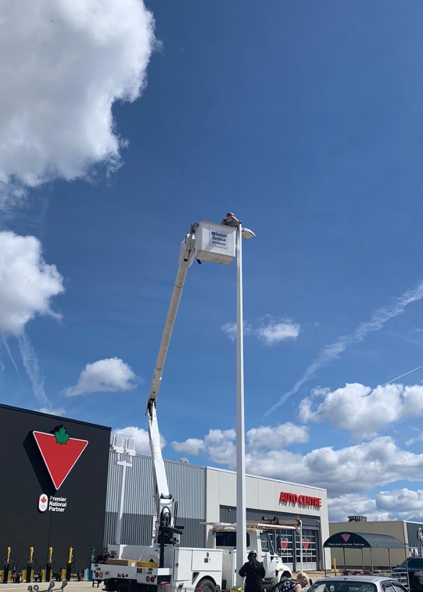 Bucket truck working on commercial site lighting